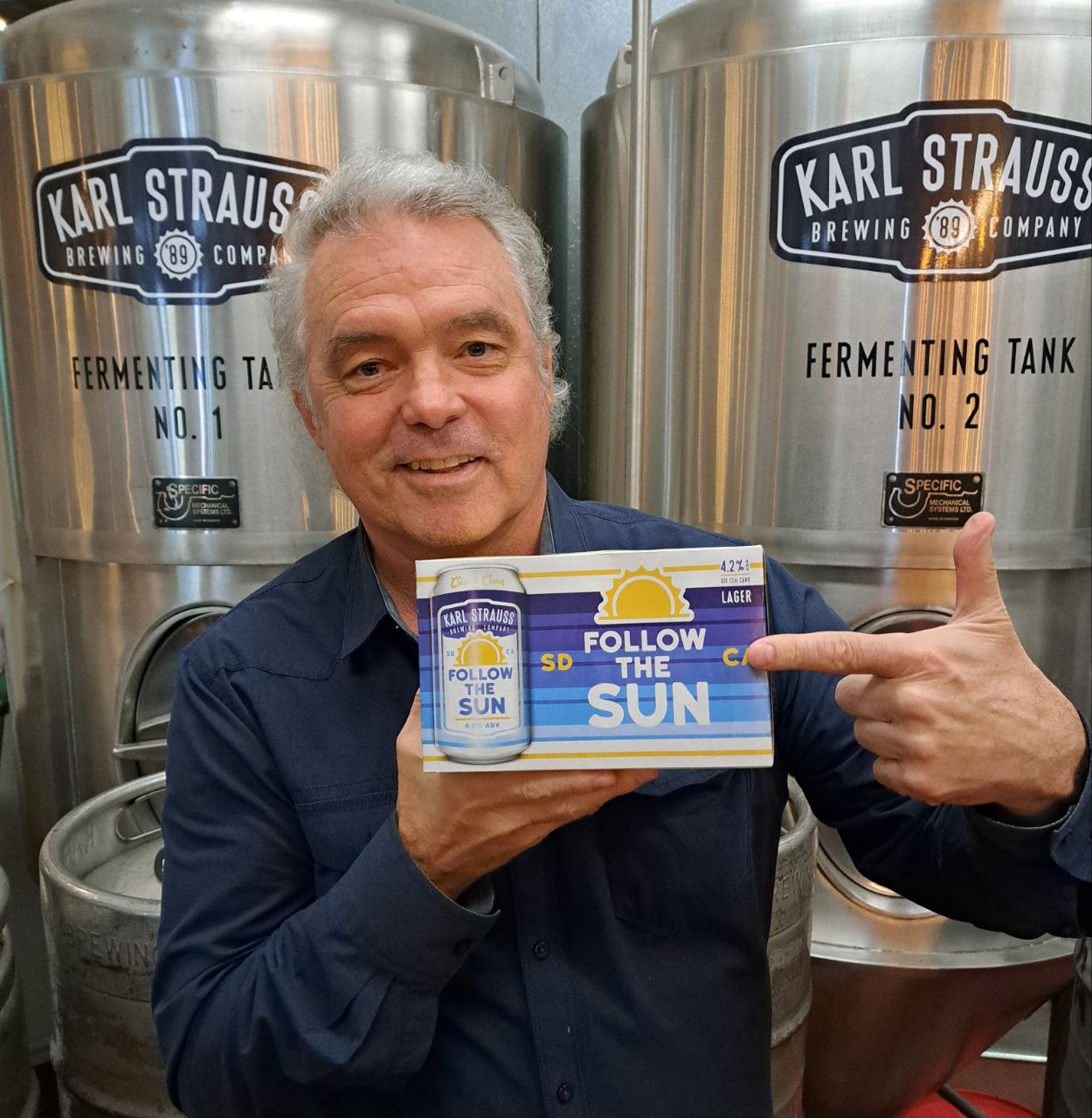 Ron Donoho holing follow the sun beer box
